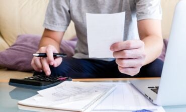 Selective,Focus,Of,Men,Using,Calculator,,Holding,Invoice,And,Check