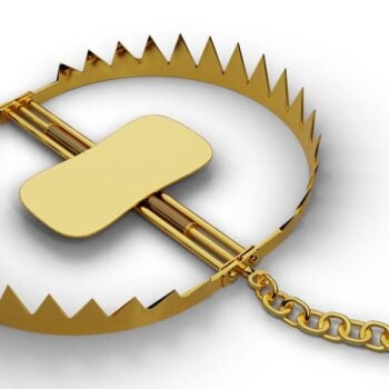Trap with gold nugget on white background.