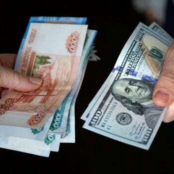 Hands,Holding,Russian,Rouble,And,Us,Dollar,Bills.,Dollars,And