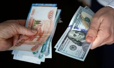 Hands,Holding,Russian,Rouble,And,Us,Dollar,Bills.,Dollars,And
